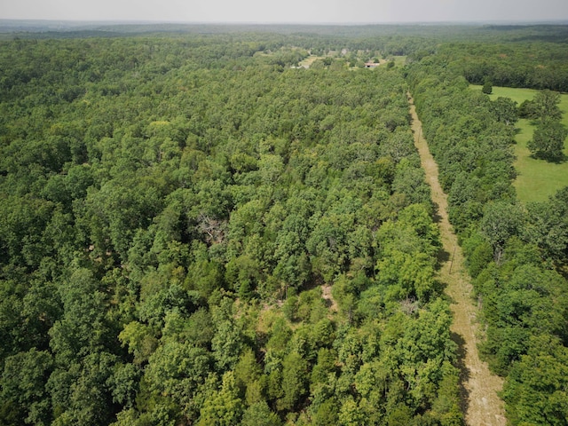 birds eye view of property featuring a wooded view