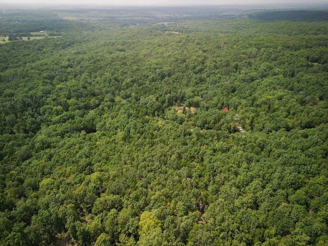 birds eye view of property with a view of trees