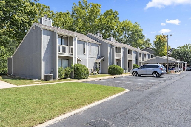 158 River Point Rd Unit 15, Hollister, MO 65672 - view of building exterior featuring uncovered parking and cooling unit