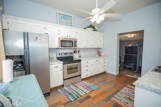 kitchen featuring appliances with stainless steel finishes, white cabinets, and dark wood finished floors