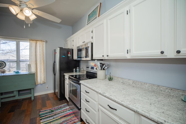 kitchen featuring light stone counters, dark wood-style flooring, white cabinetry, baseboards, and appliances with stainless steel finishes