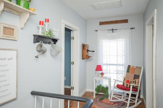 interior space featuring baseboards, visible vents, and wood finished floors