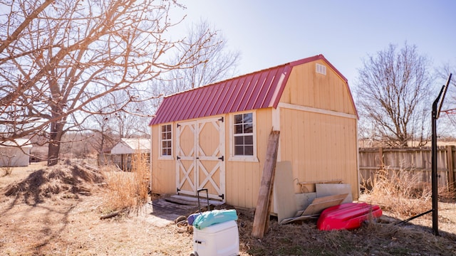 view of shed featuring fence