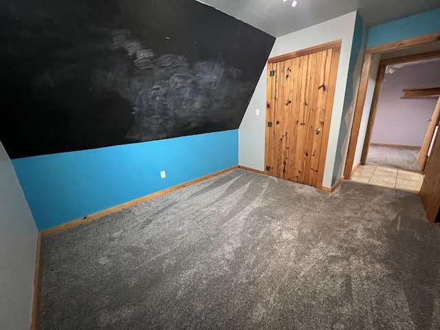 additional living space featuring carpet and baseboards