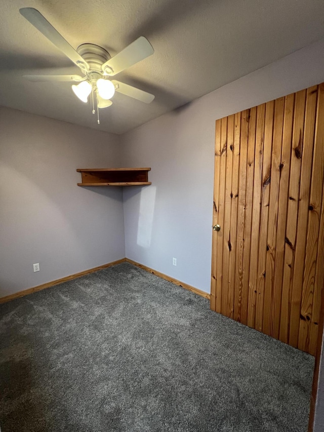 unfurnished room with carpet, baseboards, and a ceiling fan