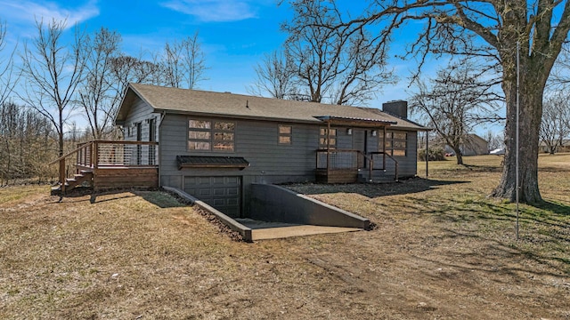 view of property exterior featuring a garage, driveway, and a chimney