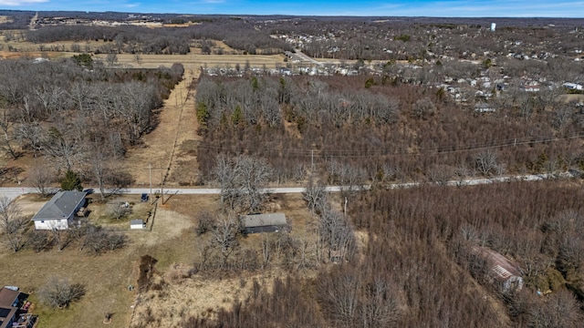 birds eye view of property with a view of trees