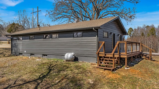 view of property exterior featuring a deck and a yard