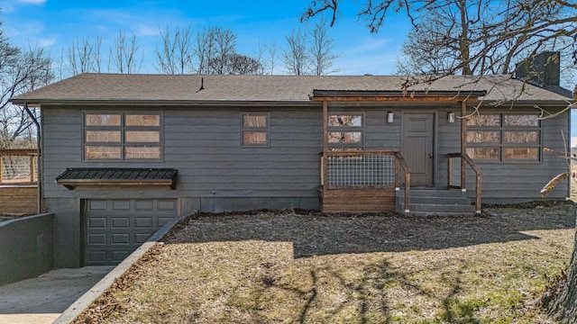 exterior space featuring driveway, a chimney, an attached garage, and fence