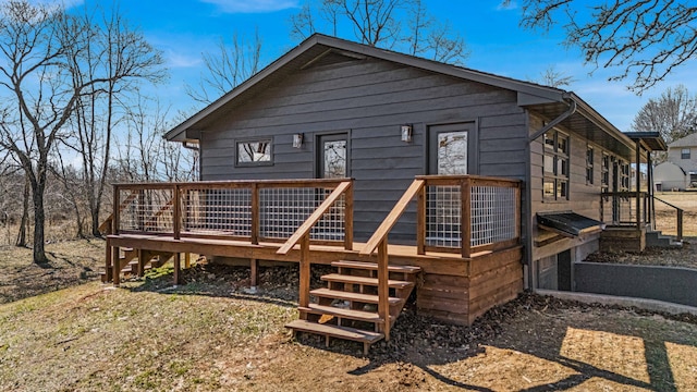 rear view of house featuring a deck