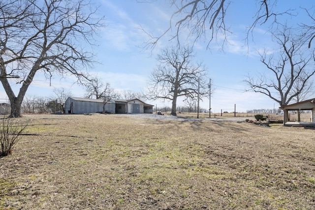 view of yard with an outbuilding and a rural view