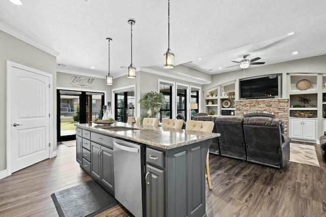 kitchen with dark wood finished floors, gray cabinets, dishwasher, and a sink