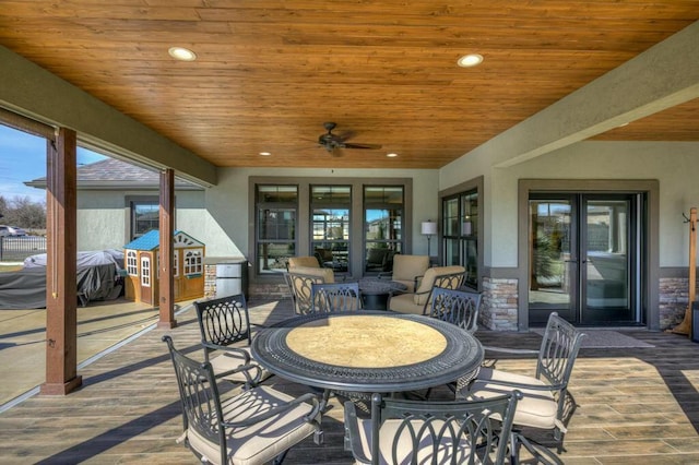 view of patio featuring outdoor dining area, a ceiling fan, and french doors