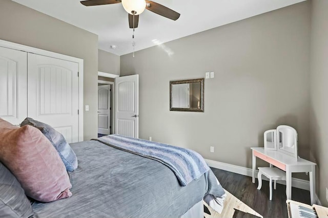 bedroom with a closet, dark wood-style flooring, baseboards, and a ceiling fan