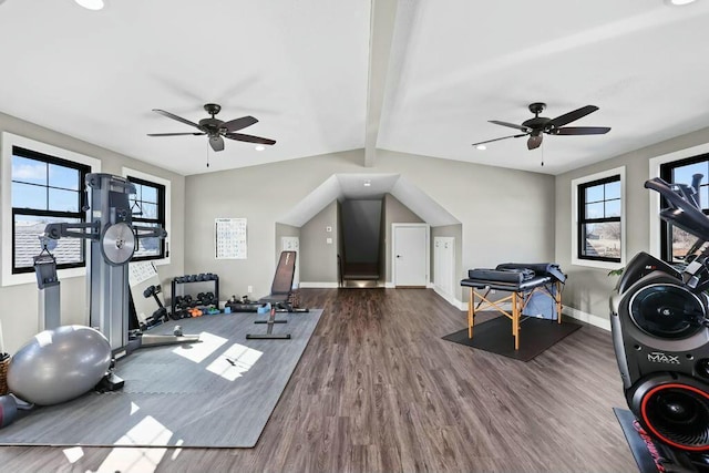 workout area featuring lofted ceiling, ceiling fan, wood finished floors, and baseboards