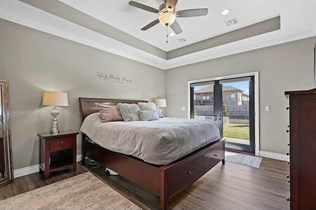 bedroom with access to exterior, visible vents, baseboards, and wood finished floors