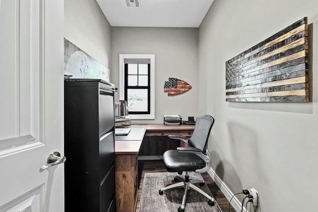 office area with baseboards, visible vents, and wood finished floors