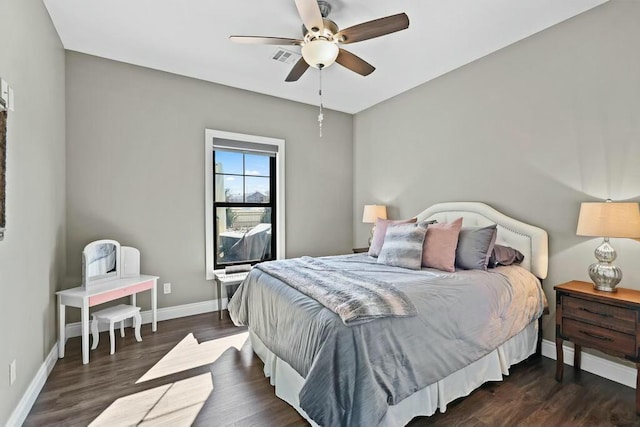 bedroom featuring visible vents, ceiling fan, baseboards, and wood finished floors