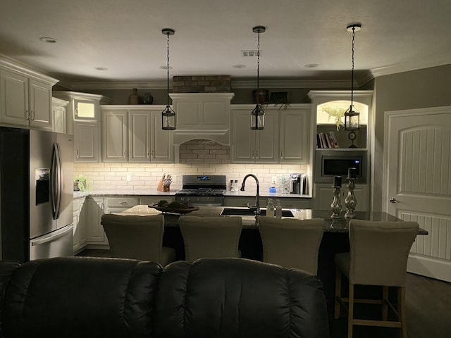 kitchen featuring stainless steel appliances, hanging light fixtures, backsplash, ornamental molding, and a sink