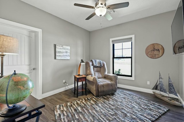 living area featuring ceiling fan, baseboards, and wood finished floors