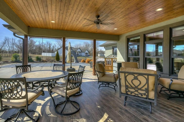 sunroom featuring wooden ceiling and ceiling fan