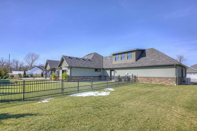 view of yard featuring central AC and fence