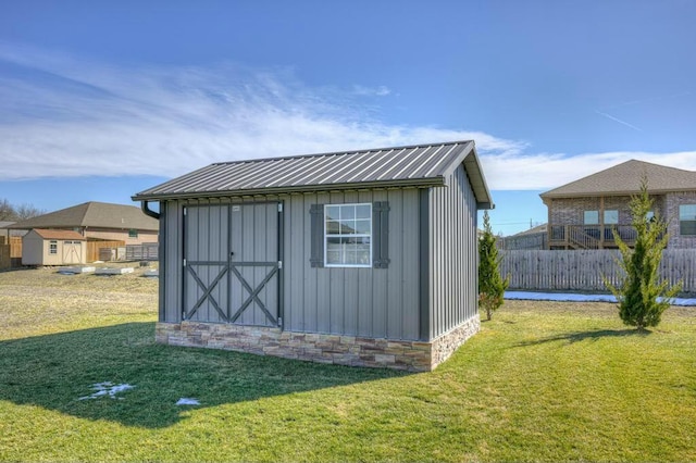 view of shed featuring fence