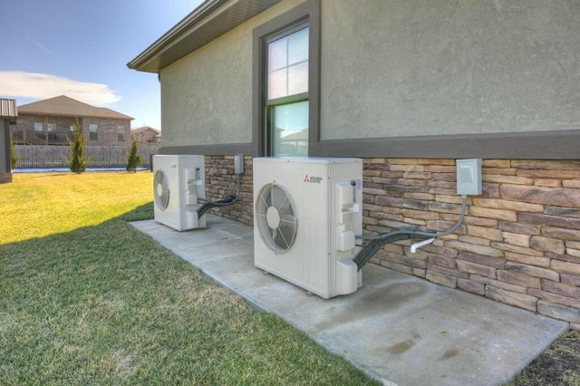 details with stone siding, ac unit, fence, and stucco siding