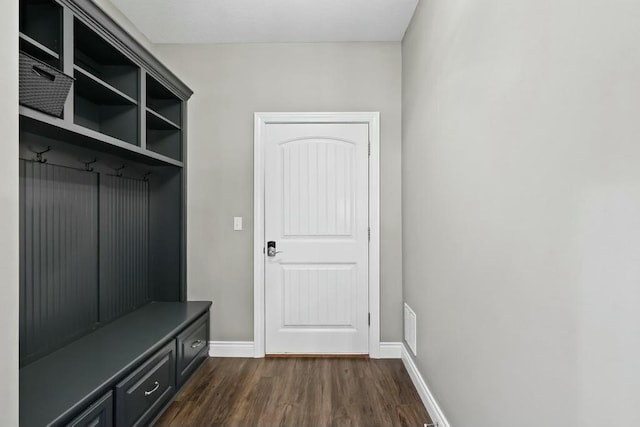 mudroom with dark wood-type flooring, visible vents, and baseboards