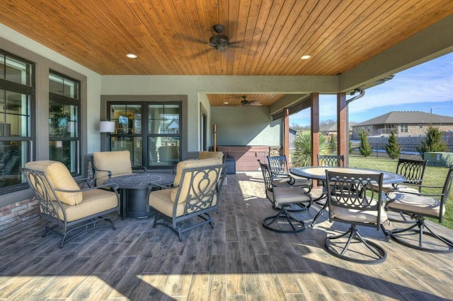 deck with outdoor dining area, ceiling fan, and fence