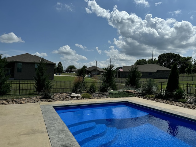 view of pool with a fenced backyard, a lawn, and a fenced in pool