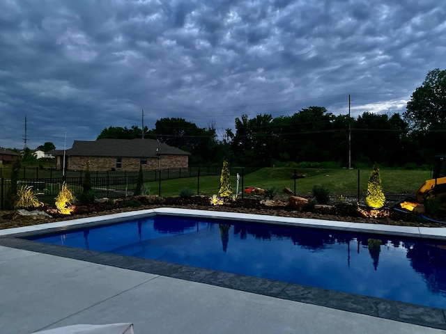 view of pool with a fenced in pool, a lawn, and fence