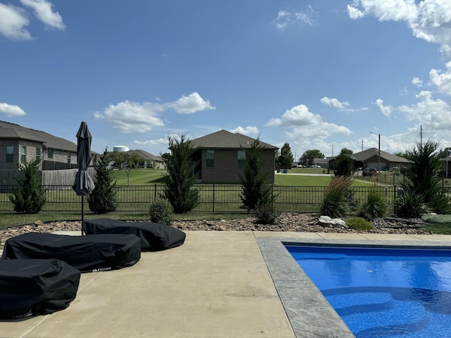 view of swimming pool featuring a fenced in pool, a yard, fence, and a patio