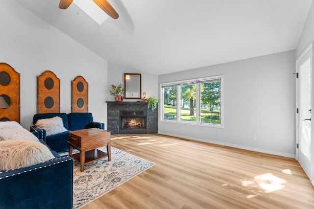 185 Eagle Pointe Dr, Branson, MO 65616 - living room with lofted ceiling, wood finished floors, ceiling fan, and a tiled fireplace