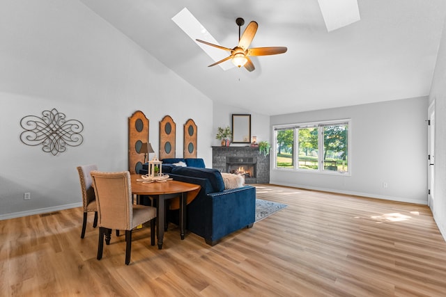 185 Eagle Pointe Dr, Branson, MO 65616 - dining room featuring a skylight, lofted ceiling, a fireplace, light wood-type flooring, and ceiling fan