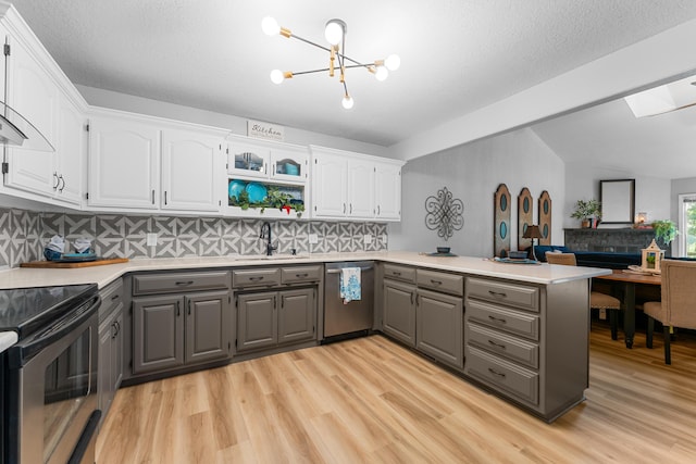 185 Eagle Pointe Dr, Branson, MO 65616 - kitchen with gray cabinetry, stainless steel appliances, a peninsula, tasteful backsplash, and lofted ceiling