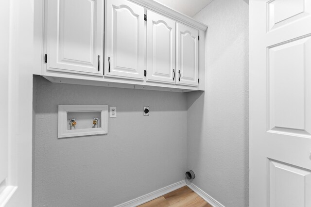 185 Eagle Pointe Dr, Branson, MO 65616 - laundry area featuring cabinet space, washer hookup, hookup for an electric dryer, and light wood-style flooring