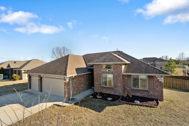 view of front of house featuring brick siding, roof with shingles, concrete driveway, an attached garage, and fence