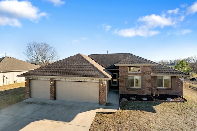 ranch-style house with a garage, concrete driveway, brick siding, and a front yard