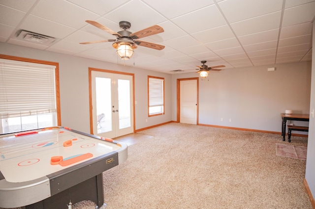 game room featuring french doors, light colored carpet, visible vents, a drop ceiling, and baseboards