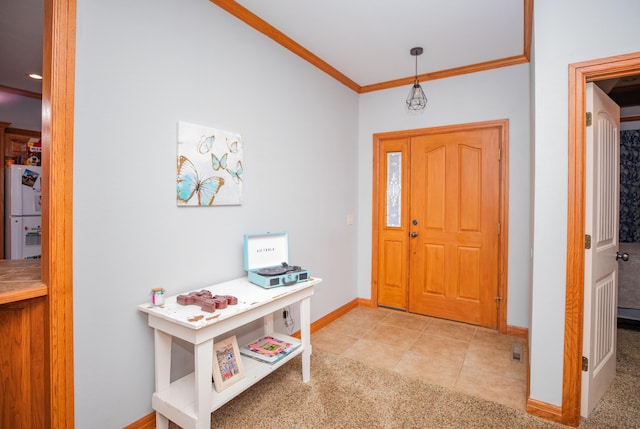 carpeted entryway featuring ornamental molding, baseboards, and tile patterned floors