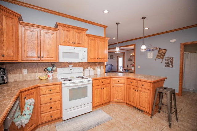 kitchen with tile countertops, tasteful backsplash, ornamental molding, white appliances, and a peninsula