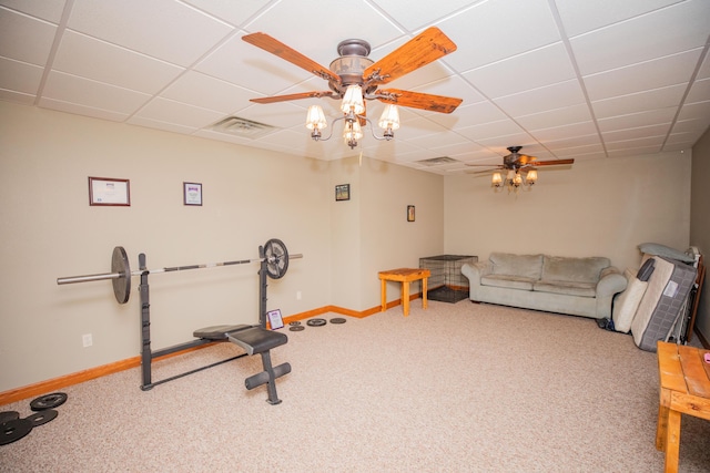 exercise room with a paneled ceiling, carpet, baseboards, and ceiling fan