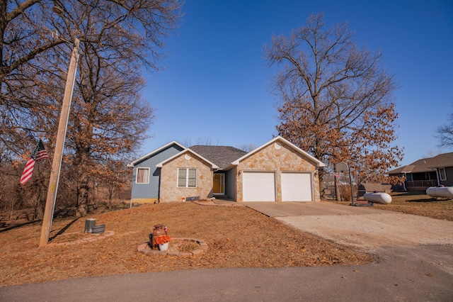 ranch-style house featuring concrete driveway and an attached garage