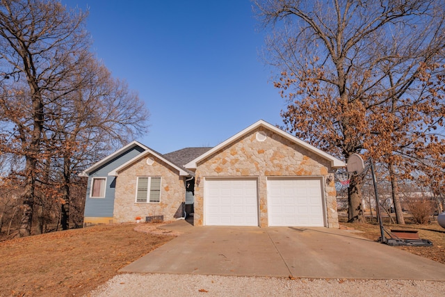 ranch-style house featuring stone siding, concrete driveway, and an attached garage