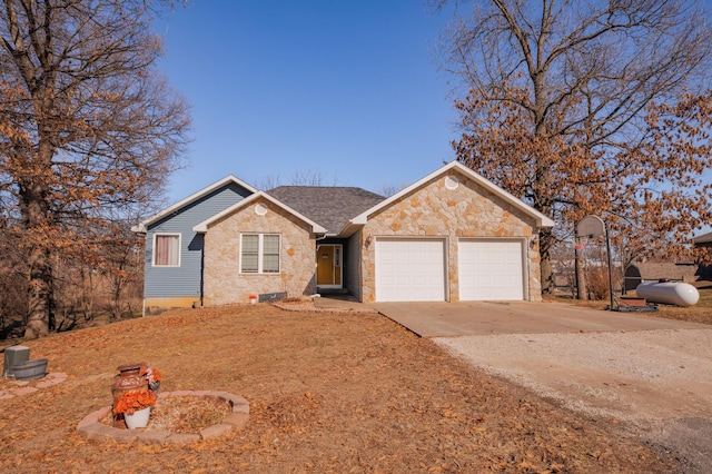 single story home with a garage, driveway, and stone siding