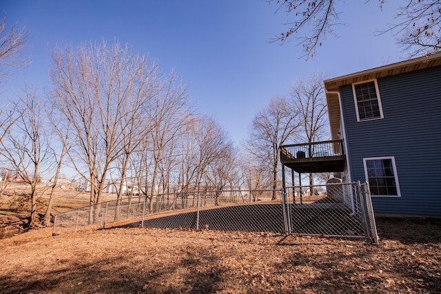 view of yard featuring a gate, fence, and a wooden deck