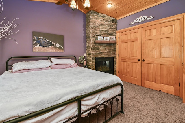 carpeted bedroom with wood ceiling, a fireplace, and vaulted ceiling