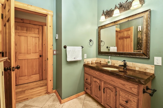 bathroom with tile patterned flooring, vanity, and baseboards