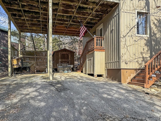 view of patio with an outdoor structure and a storage unit